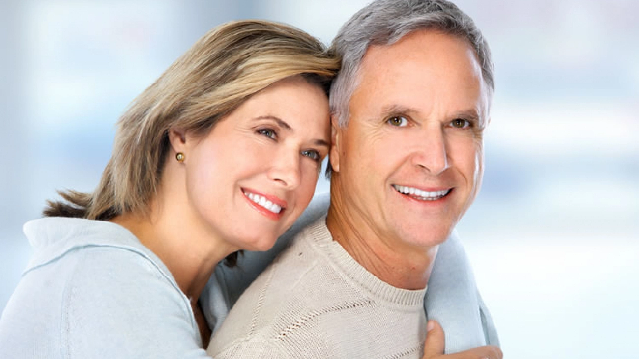 Happy couple with dental implants