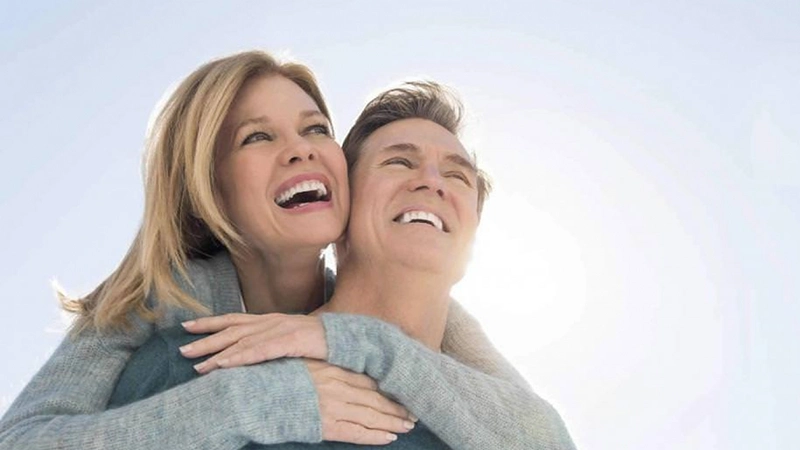 Happy couple with dental implants