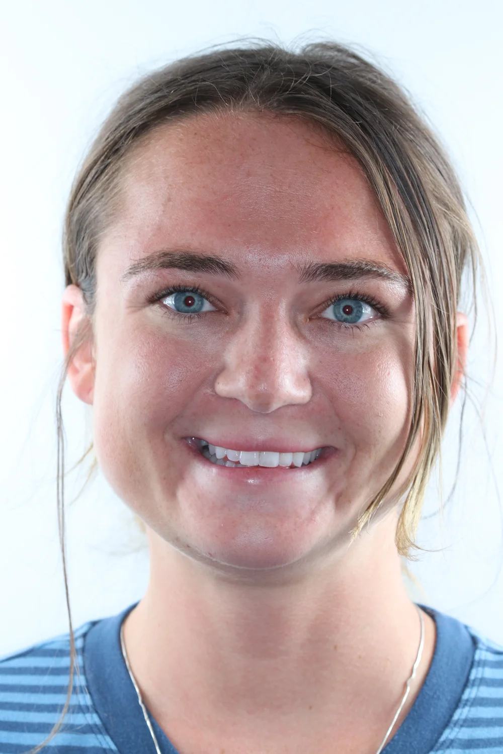 Nicole R. smiling after dental implant care at Balboa Dentistry in San Diego.
